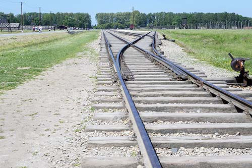 Photograph of Birkenau tracks from just inside the entrance gate in May 2017.